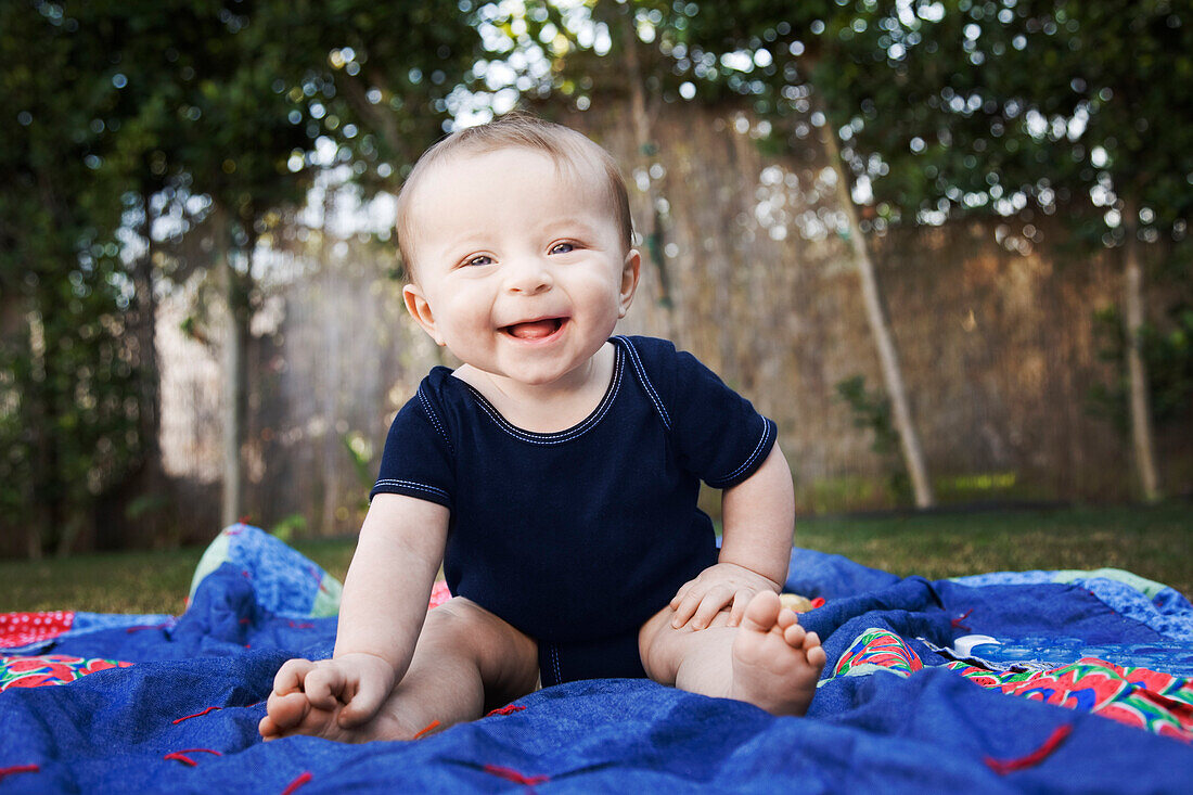 Baby Sitting on Blanket Outside