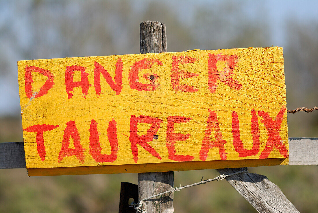 Danger Sign on Wooden Fence