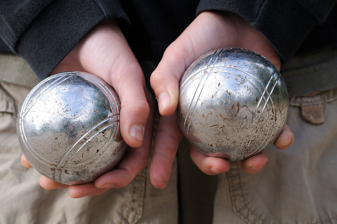 Boy's Hands Holding Petanque Balls