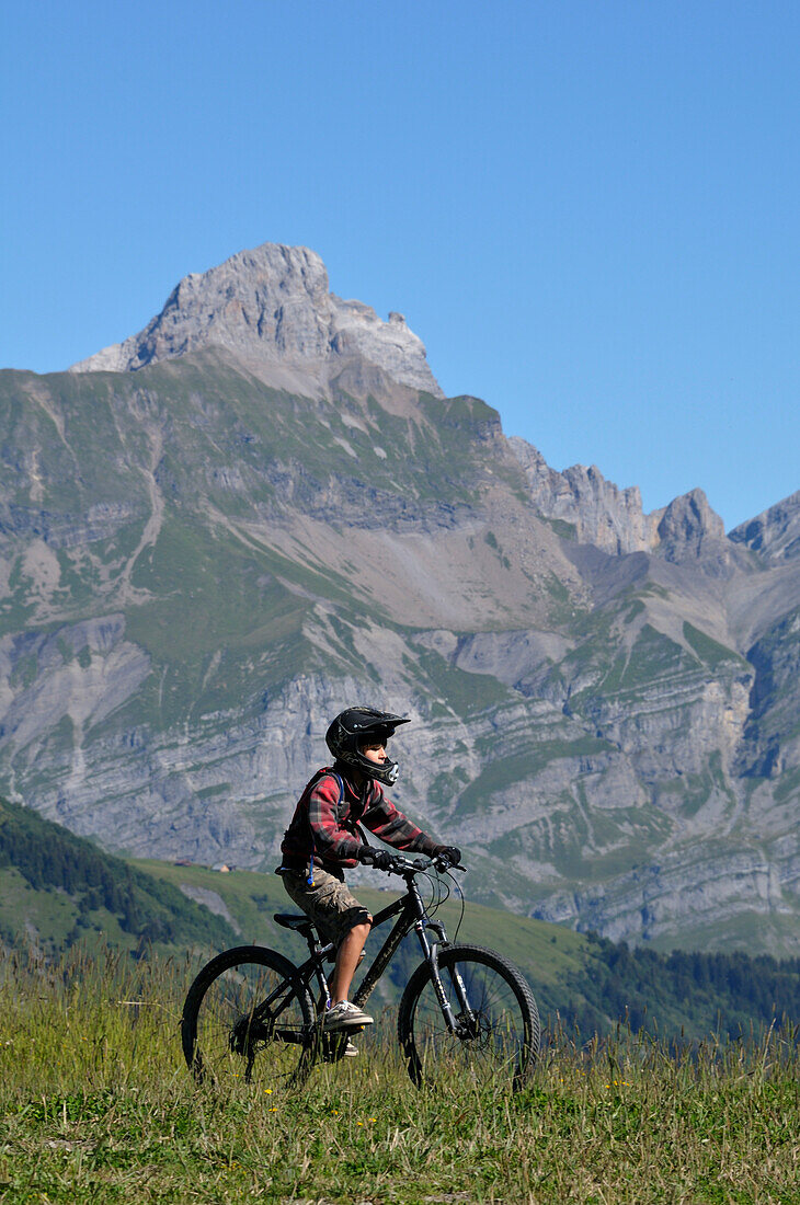 Boy Riding Bicycle in Mountains,Alps,France