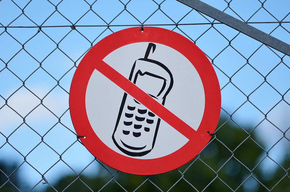 Close-up of,No Cellphone Sign on Fence