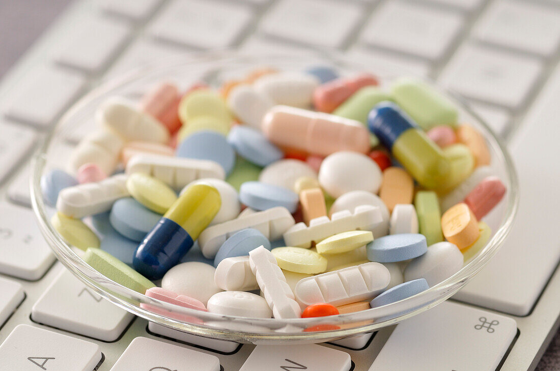 Dish of Pills on Computer Keyboard