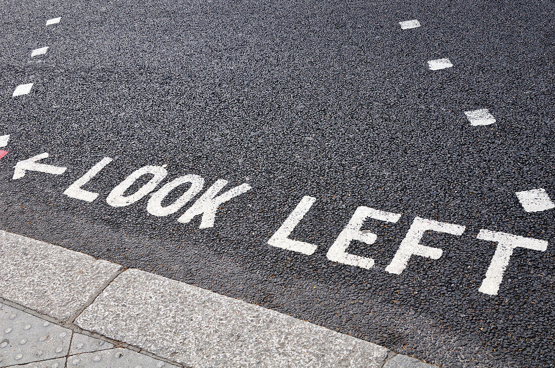 Look Left Warning at Crossing on Road