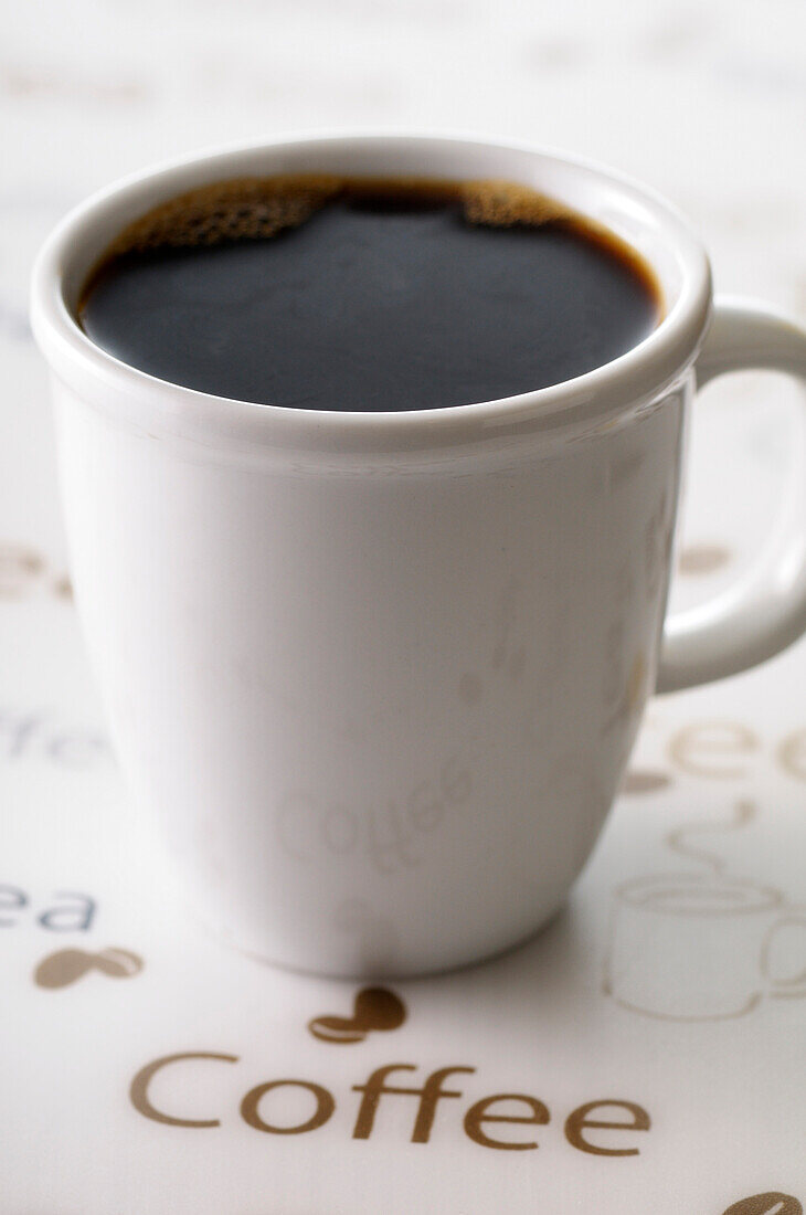 Close-up of Cup of Black Coffee with Coffee Text,Studio Shot