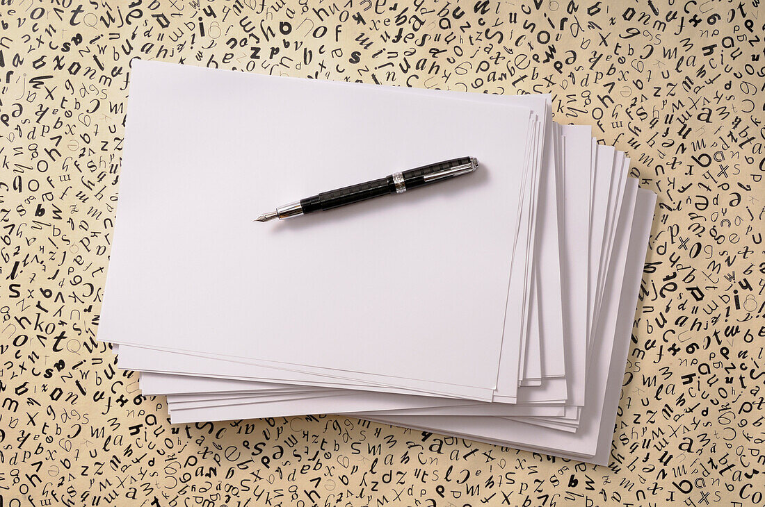 Overhead View of Pen on Stack of Paper