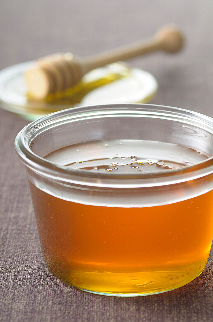 Close-up of Honey with Honey Dipper in Background
