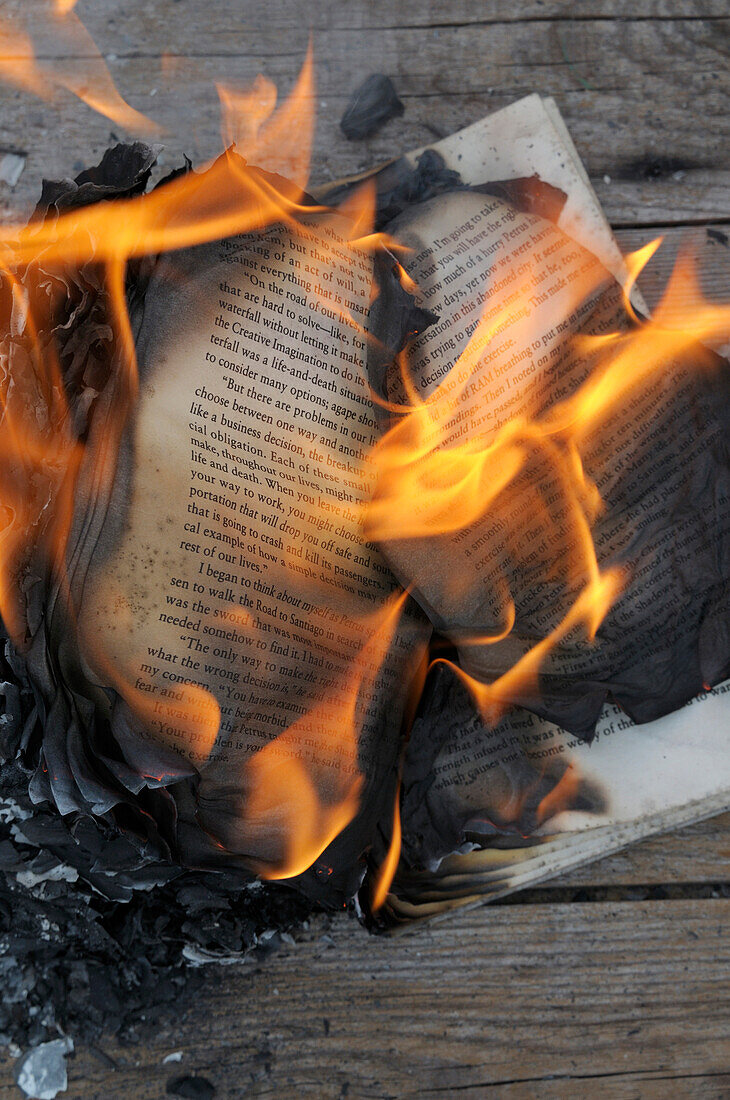 Burning Book on Wooden Background
