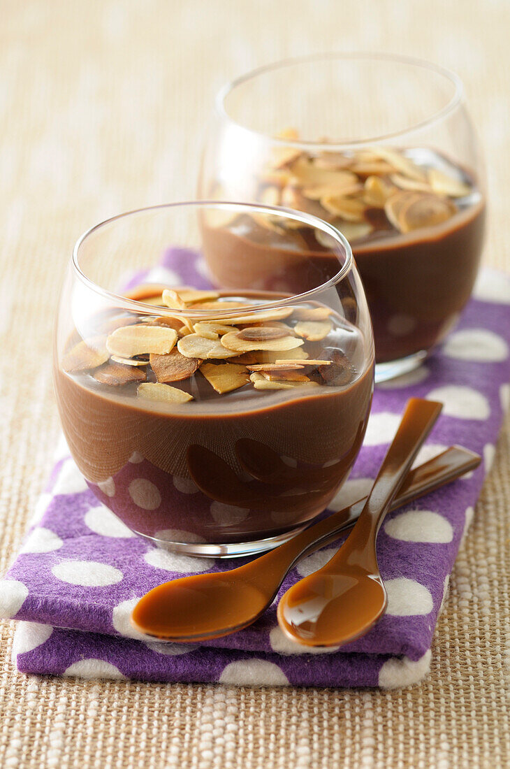 Close-up of Glasses of Chocolate Pudding with Slivered Toasted Nuts