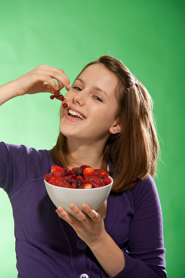 Teenage Girl Eating Bowl of Berries