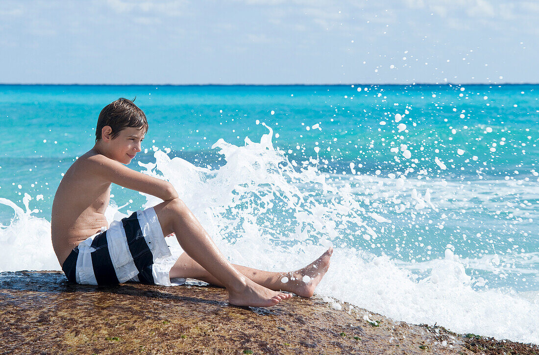 Boy Sitting by Surf,Playa del Carmen,Yucatan Peninsula,Mexico