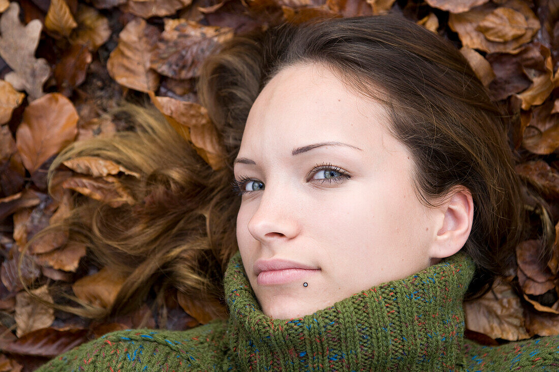 Woman Lying Down in Autumn Leaves,Mannheim,Baden-Wurttemberg,Germany