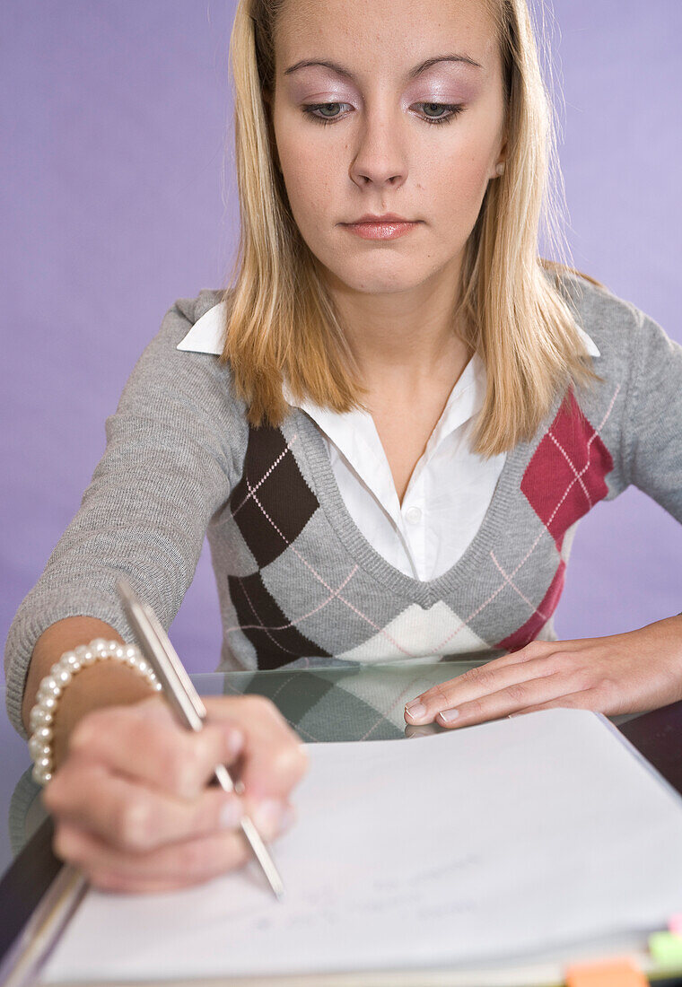 Young Woman Writing in Notebook