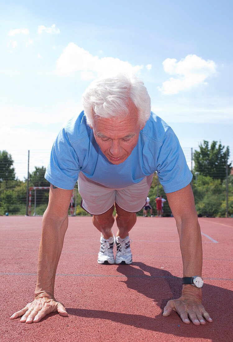 Man Exercising Outdoors on Track