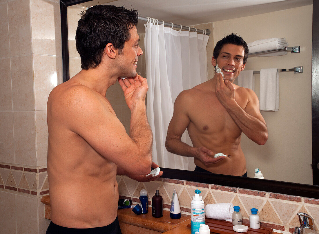 Man Shaving in Hotel Room,Reef Playacar Resort and Spa,Playa del Carmen,Mexico