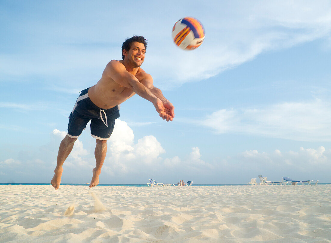 Man Playing Volleyball on Beach,Mexico