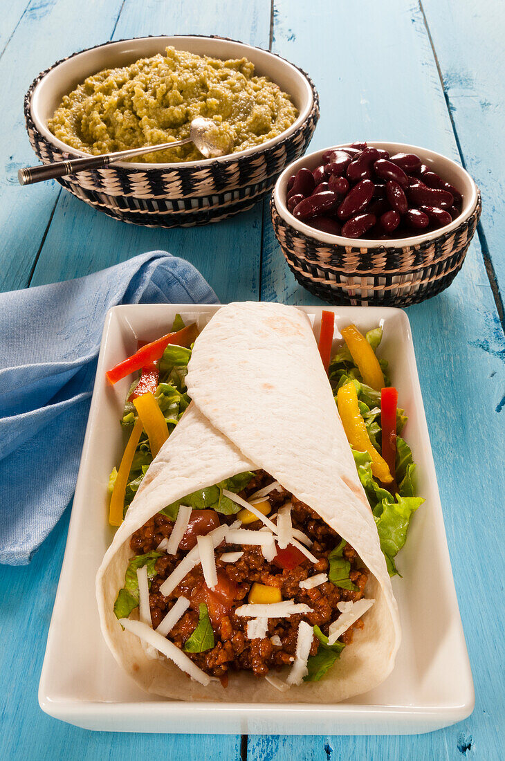 Minced meat Taco in flour Tortilla with guacamole and beans,Mexico,North America