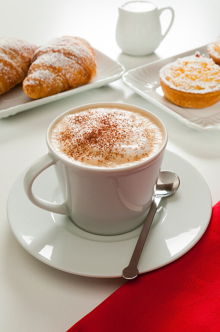 Cappuccino with croissant and rice puddings (budini di riso),Italy,Europe