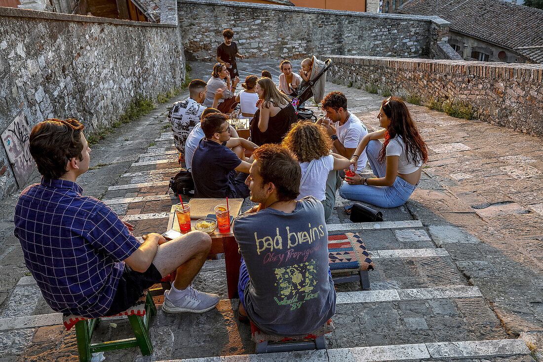 Young people sitting in a bar located on an urban staircase in Perugia,Umbria,Italy,Europe