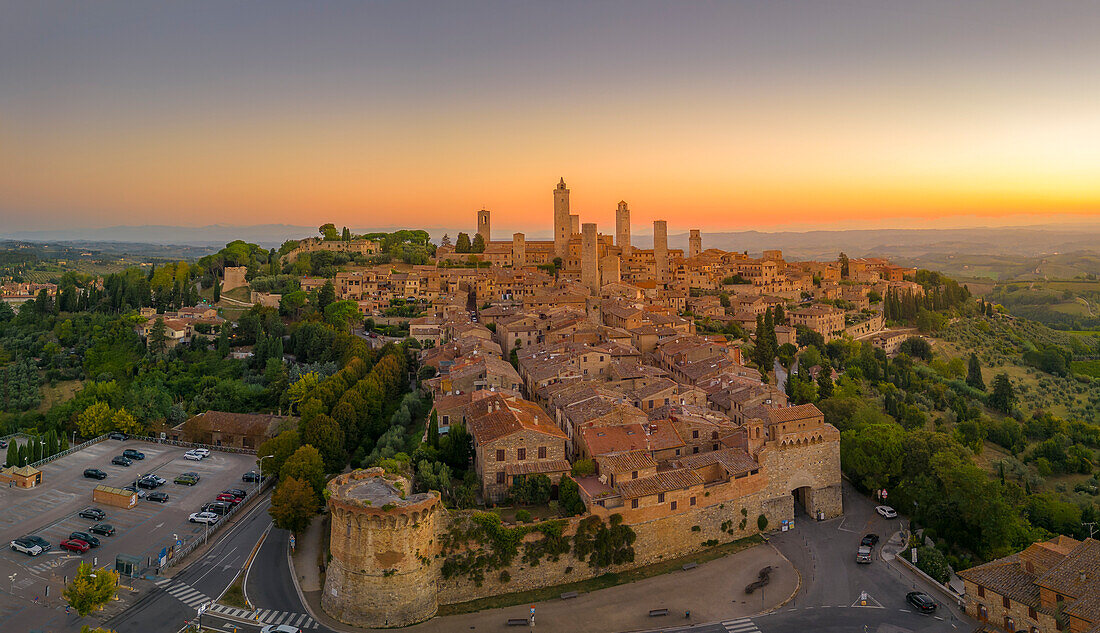 Elevated view of rooftops and town at sunrise,San Gimignano,Tuscany,Italy,Europe
