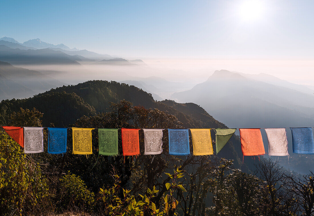 Colorful prayer flags in front of a vast mountain landscape at the foot of the Annapurna Circuit in the Himalayas,Australian Camp,Nepal,Asia
