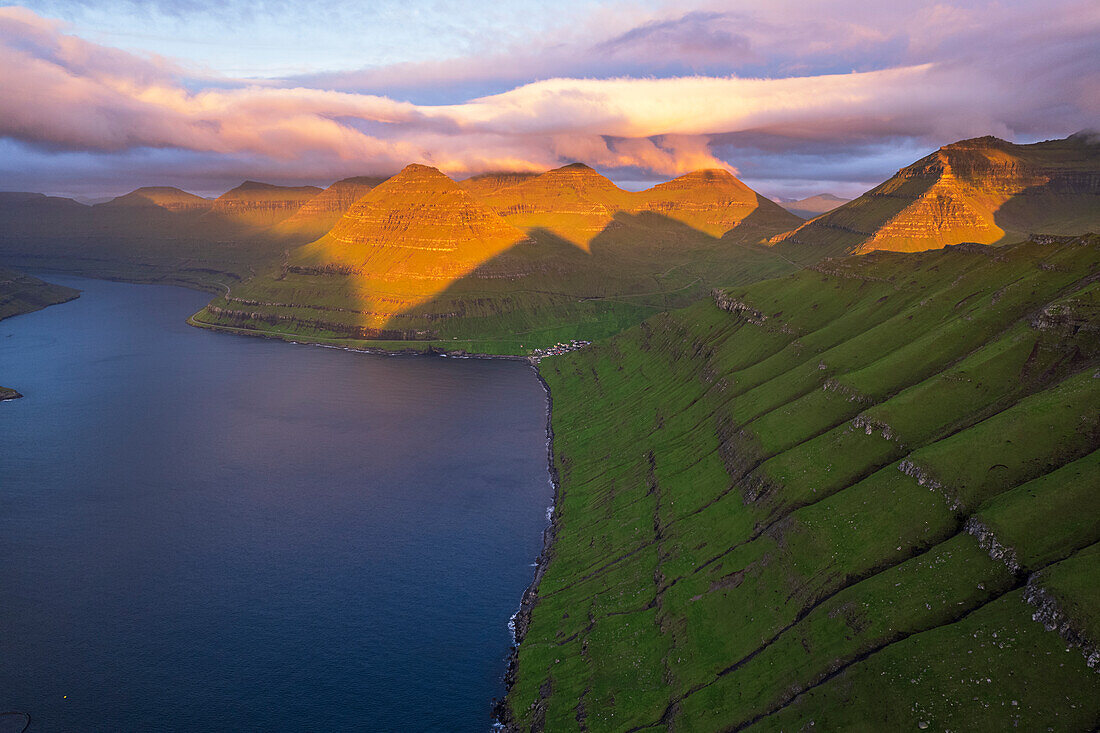 Aerial shot of the dramatic view of Funningur with pink sky at dawn,Eysturoy island,Faroe islands,Denmark,Europe