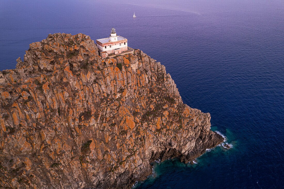 Punta della Guardia basalt cliff with the lighthouse at dusk,Ponza island,Tyrrhenian Sea,Pontine islands,Latina Province,Latium (Lazio),Italy,Europe