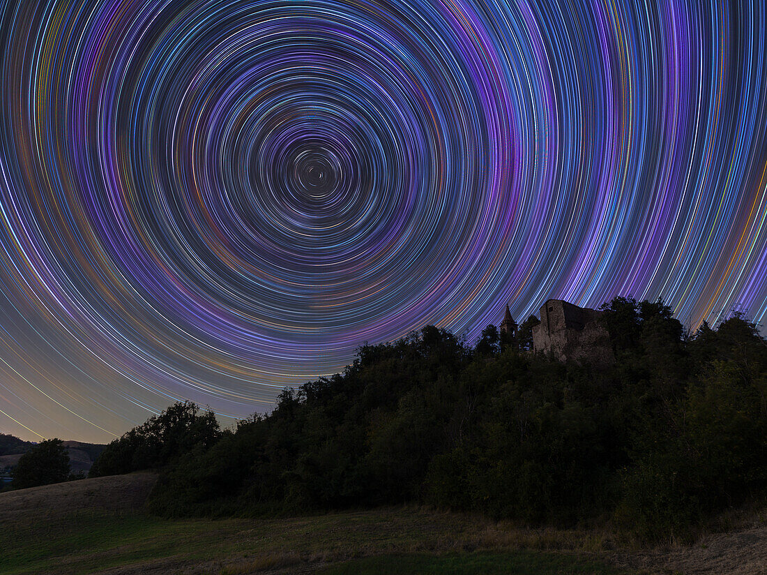 Concentric star trail over a medieval castle in the Italian countryside,Emilia Romagna,Italy,Europe