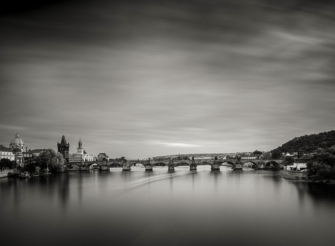 Pleasure cruiser moving beneath Charles Bridge,Prague,Czechia (Czech Republic),Europe