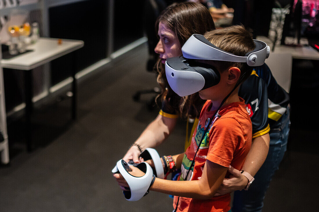 Kleiner Junge spielt mit dem Meta Quest 2 All-in-One VR-Headset während des ZGamer, einem Festival für Videospiele, digitale Unterhaltung, Brettspiele und YouTuber während der El Pilar Fiestas in Zaragoza, Aragonien, Spanien