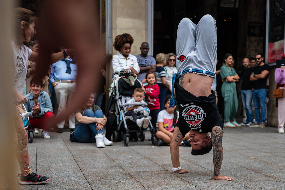 Members of Mestre Branco Capoeira Escola demonstrate in the street during the Fiestas of El Pilar in Zaragoza,Aragon,Spain