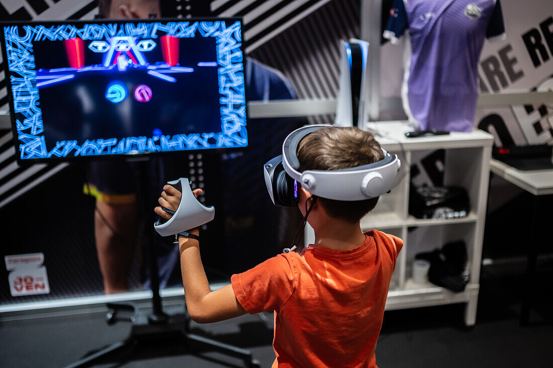 Kleiner Junge spielt mit dem Meta Quest 2 All-in-One VR-Headset während des ZGamer, einem Festival für Videospiele, digitale Unterhaltung, Brettspiele und YouTuber während der El Pilar Fiestas in Zaragoza, Aragonien, Spanien