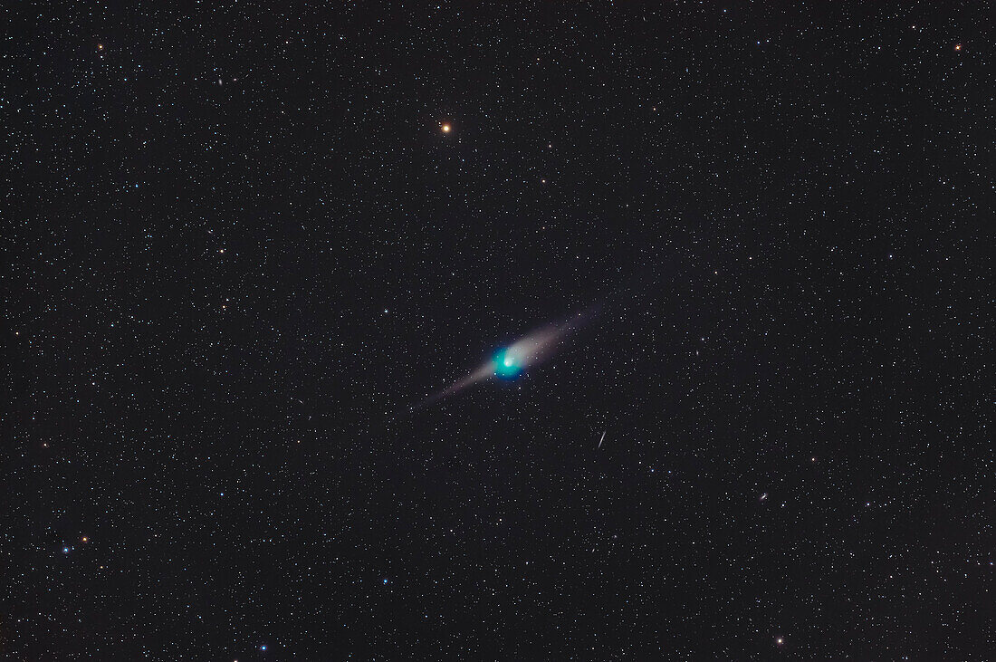 Comet C/2022 E3 (ZTF) on the night of January 22/23,2023 when it was in Draco,with it near the reddish star Edasich (aka Iota Draconis) at top,and the edge-on galaxy NGC 5907 below the comet. To the right of that galaxy is NGC 5866,aka M102. The dust tail of the comet was showing a strong anti-tail spike ahead of the comet's greenish coma,as this was two days before we crossed the plane of the comet's orbit when we would see its dust tail "edge-on." The coma of the comet is strongly cyan or green from glowing diatomic carbon molecules,common for comets. There was little sign of the blue ion ta