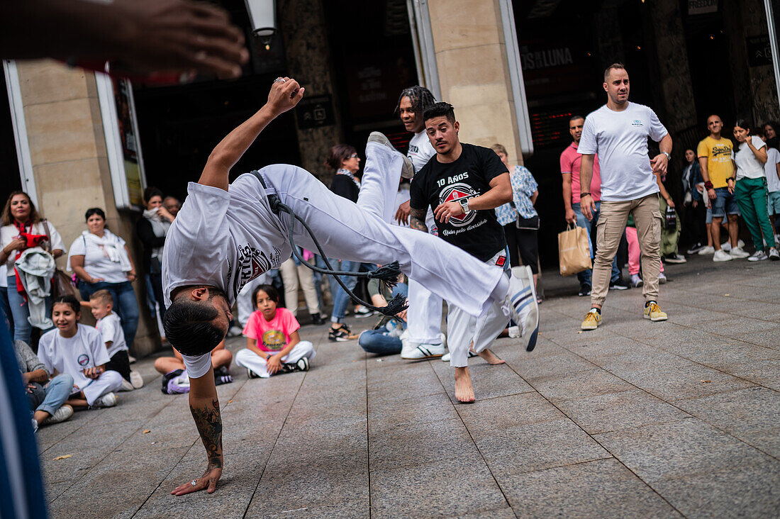 Members of Mestre Branco Capoeira Escola demonstrate in the street during the Fiestas of El Pilar in Zaragoza,Aragon,Spain