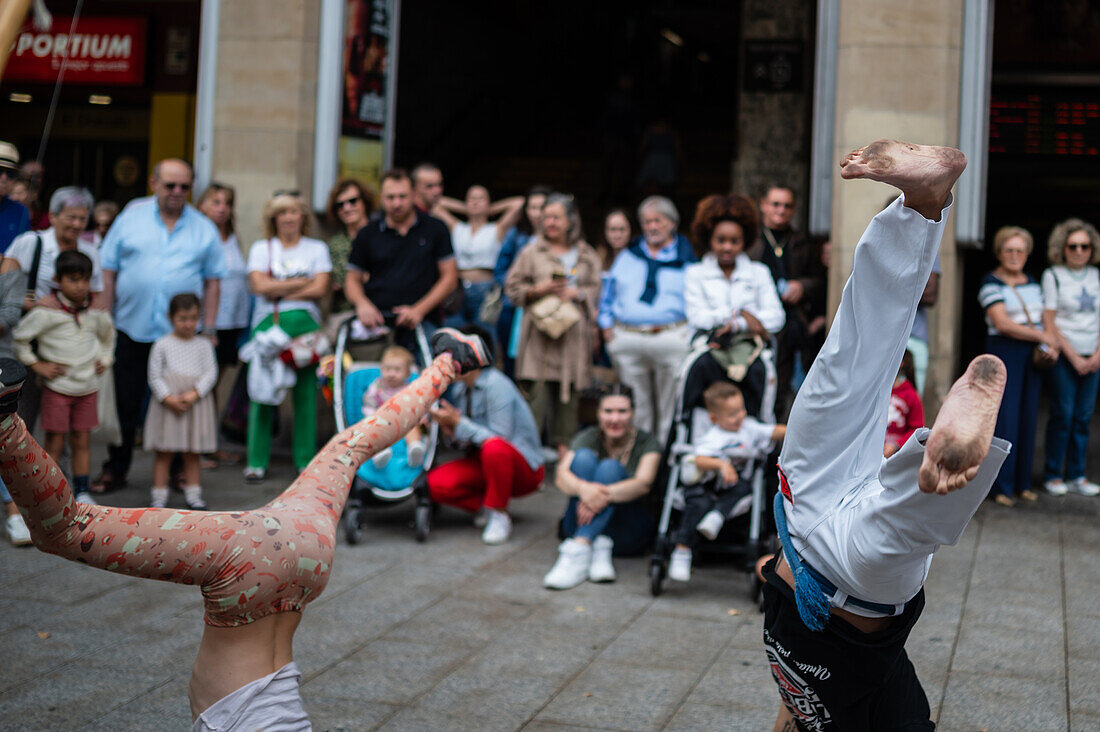 Members of Mestre Branco Capoeira Escola demonstrate in the street during the Fiestas of El Pilar in Zaragoza,Aragon,Spain