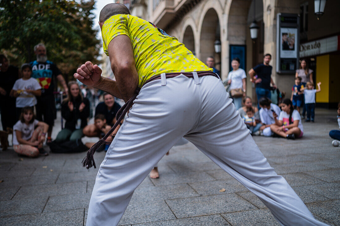 Members of Mestre Branco Capoeira Escola demonstrate in the street during the Fiestas of El Pilar in Zaragoza,Aragon,Spain