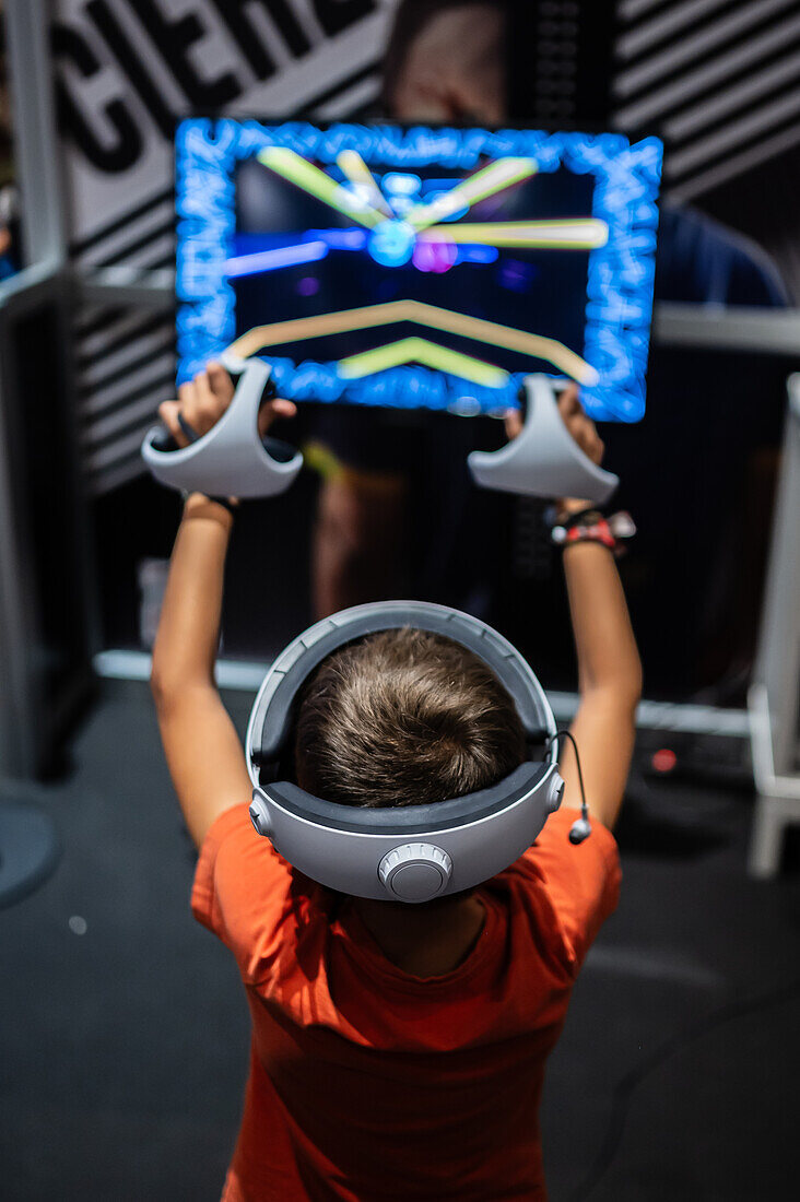 Junger Junge spielt mit Meta Quest 2 All-in-One VR-Headset während ZGamer, einem Festival für Videospiele, digitale Unterhaltung, Brettspiele und YouTuber während der El Pilar Fiestas in Zaragoza, Aragon, Spanien
