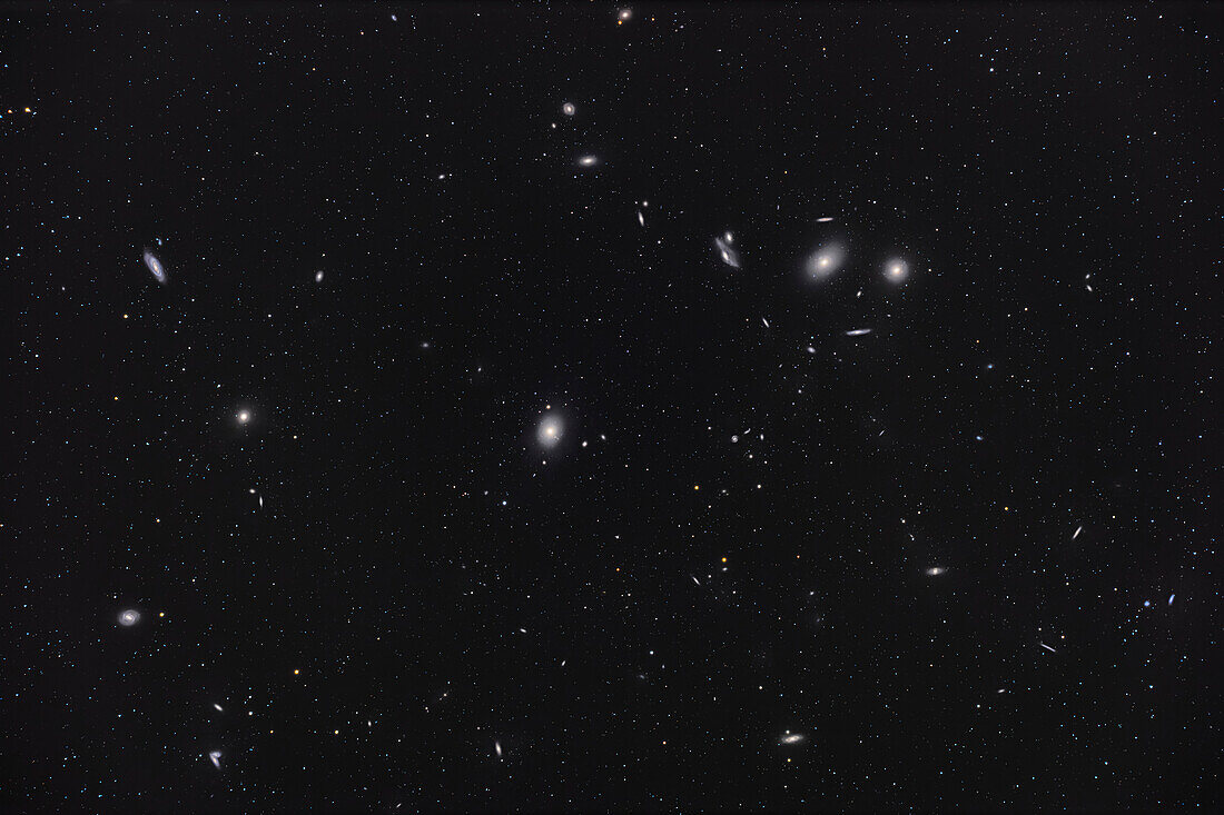 A framing of the core of the great Coma-Virgo Galaxy Cluster,with the bright pair of elliptical Messier-catalogue galaxies M84 (right) and M86 (on the left) at upper right anchoring the arc of galaxies called Markarian's Chain. At centre is the giant elliptical M87,famous for its monster black hole. M89,a smaller elliptical,is to the left,and M90,a spiral galaxy,is above it. M58 is at lower left,and the pair of interacting galaxies called the Siamese Twins,NGC 4568,are at bottom left. Dozens of other NGC,IC and PGC galaxies down to 15th magnitude dot the field.