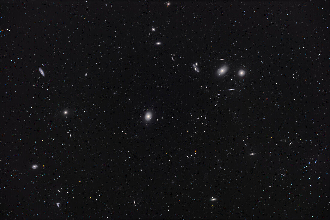 Eine Aufnahme des Kerns des großen Coma-Virgo-Galaxienhaufens mit dem hellen Paar der elliptischen Messier-Katalog-Galaxien M84 (rechts) und M86 (links) oben rechts, die den Galaxienbogen namens Markarians Kette verankern. In der Mitte befindet sich die riesige elliptische Galaxie M87, die für ihr monströses Schwarzes Loch bekannt ist. M89, eine kleinere elliptische Galaxie, befindet sich links davon, und M90, eine Spiralgalaxie, liegt darüber. M58 befindet sich unten links, und das Paar interagierender Galaxien, die so genannten Siamesischen Zwillinge (NGC 4568), befindet sich unten links. Du