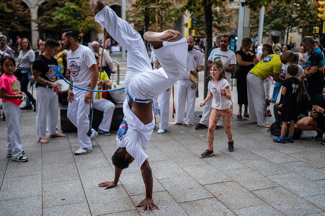 Members of Mestre Branco Capoeira Escola demonstrate in the street during the Fiestas of El Pilar in Zaragoza,Aragon,Spain