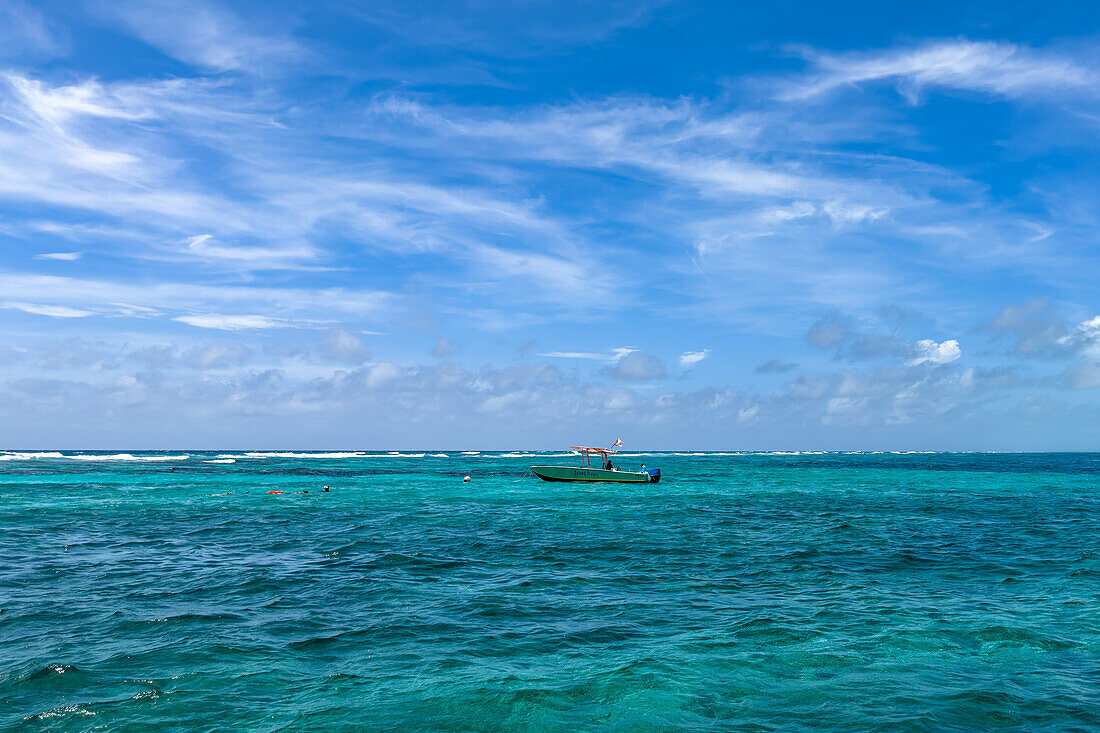 A dive boat and snorkelers in the Hol Chan Marine Reserve on the Belize Barrier Reef near Ambergris Caye,Belize.
