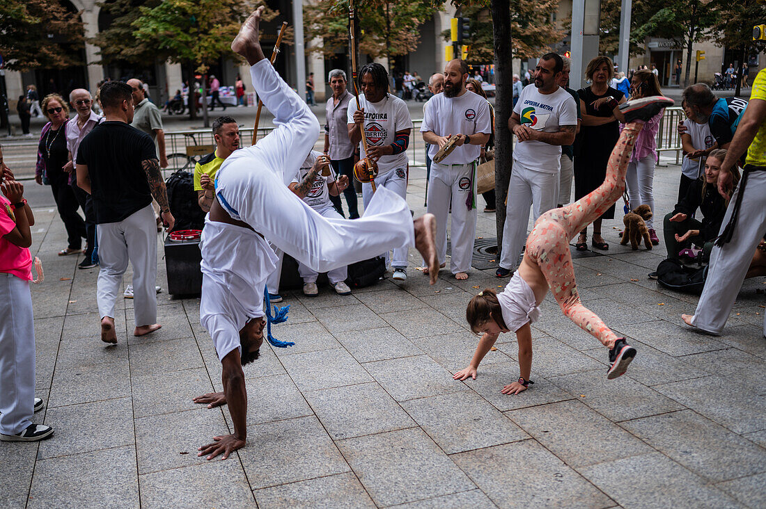 Members of Mestre Branco Capoeira Escola demonstrate in the street during the Fiestas of El Pilar in Zaragoza,Aragon,Spain