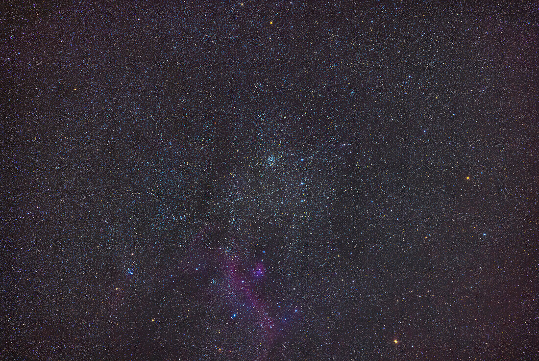 The star cluster Messier 50 in Monoceros the Unicorn,in a wide-field telephoto image simulating the feld of view of binoculars. The Seagull Nebula shows up at bottom. To the left is the cluster NGC 2353.