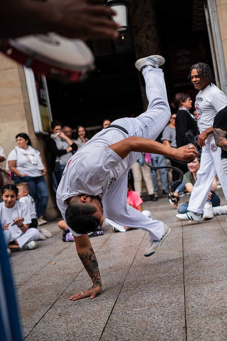 Members of Mestre Branco Capoeira Escola demonstrate in the street during the Fiestas of El Pilar in Zaragoza,Aragon,Spain