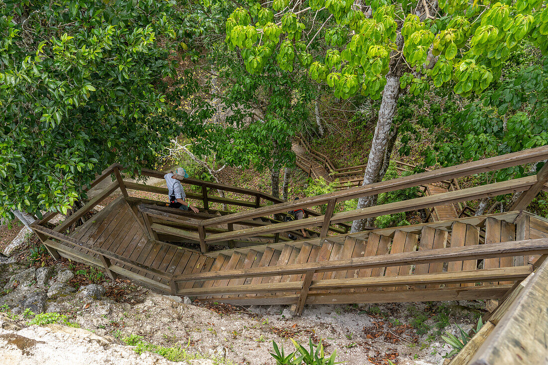 A tourist descends the stairs of Structure 216 in the Mayan ruins in Yaxha-Nakun-Naranjo National Park,Guatemala. Structure 216 is the tallest pyramid in the Yaxha ruins.