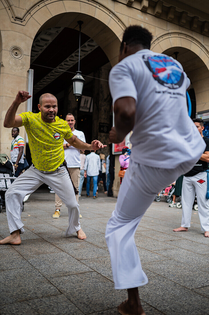 Members of Mestre Branco Capoeira Escola demonstrate in the street during the Fiestas of El Pilar in Zaragoza,Aragon,Spain