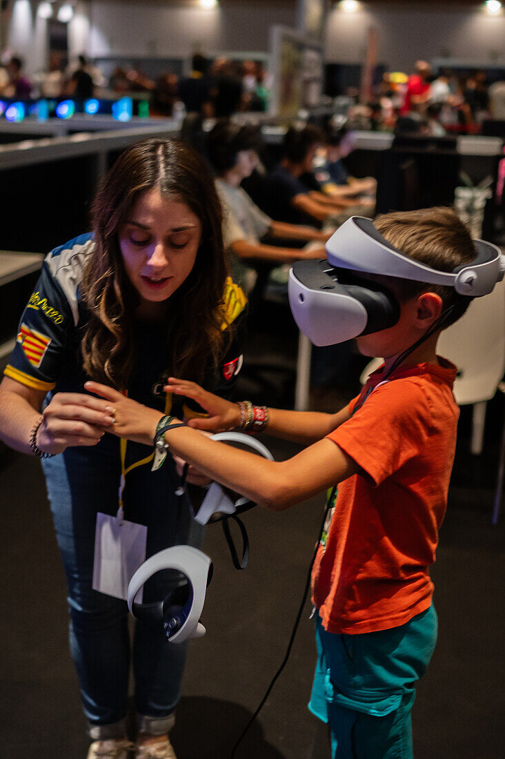 Kleiner Junge spielt mit dem Meta Quest 2 All-in-One VR-Headset während des ZGamer, einem Festival für Videospiele, digitale Unterhaltung, Brettspiele und YouTuber während der El Pilar Fiestas in Zaragoza, Aragonien, Spanien