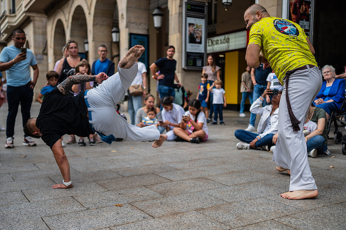 Members of Mestre Branco Capoeira Escola demonstrate in the street during the Fiestas of El Pilar in Zaragoza,Aragon,Spain