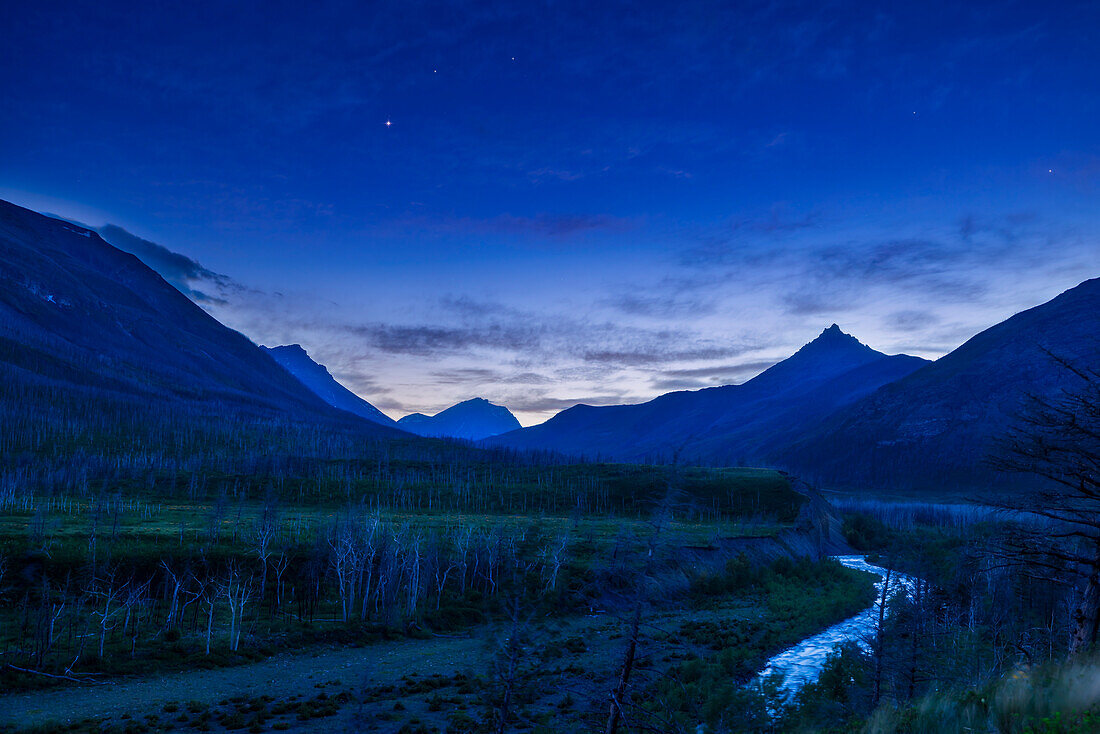 Venus as a bright evening star over the Blakiston Valley and Creek in Waterton Lakes National Park,May 29,2023. Above Venus are the stars Pollux and Castor in Gemini. The valley was ravaged by a forest fire in September 2017.