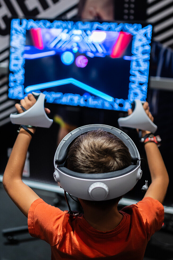 Young boy playing with Meta Quest 2 all-in-one VR headset during ZGamer,a festival of video games,digital entertainment,board games and YouTubers during El Pilar Fiestas in Zaragoza,Aragon,Spain