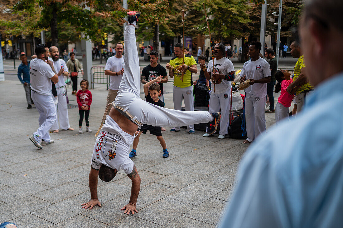 Members of Mestre Branco Capoeira Escola demonstrate in the street during the Fiestas of El Pilar in Zaragoza,Aragon,Spain